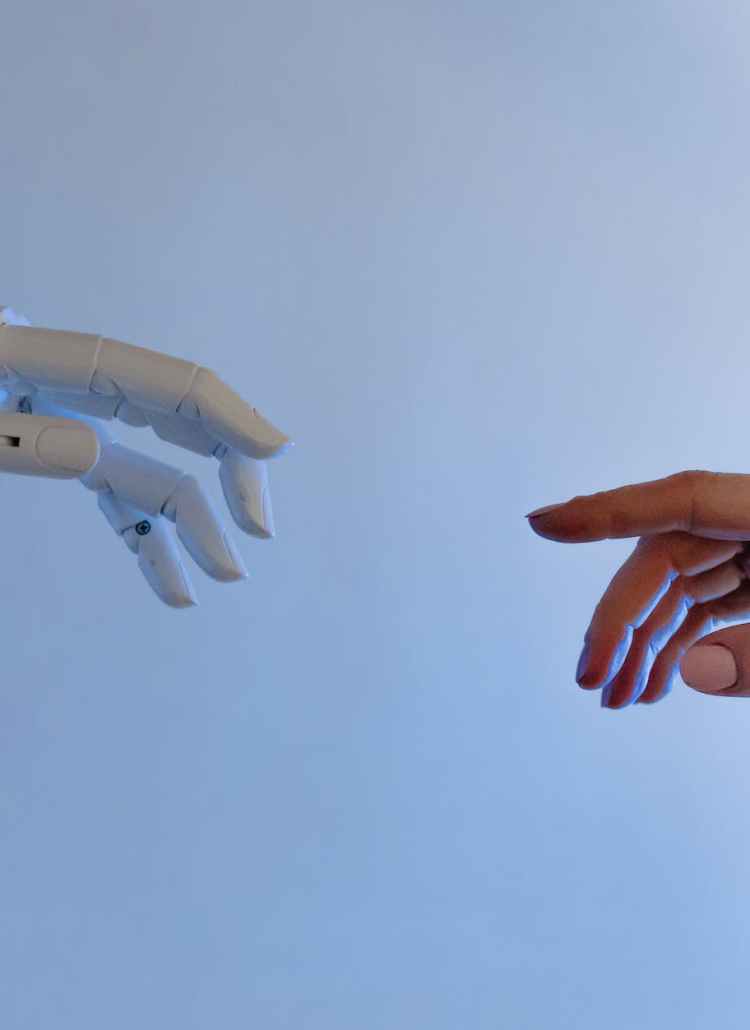 person reaching out to a robot