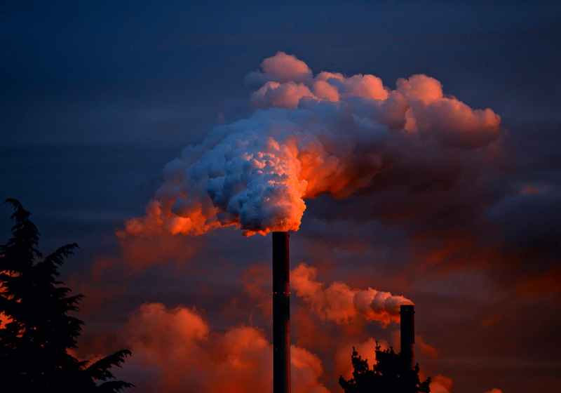 smoke coming out of factory pipes